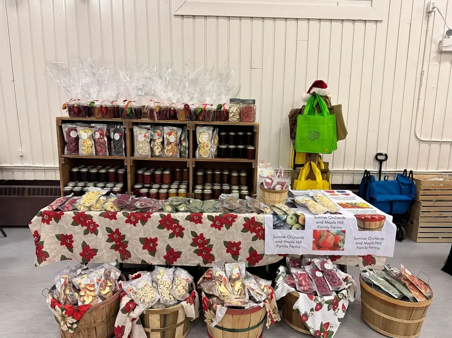 The Sunrise Orchards market table stocked with jams and freeze-dried fruit